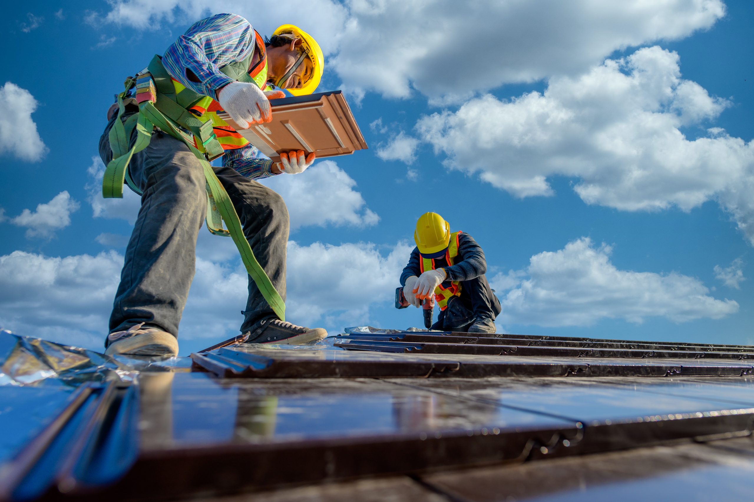 Workers Repairing A Tile Roof